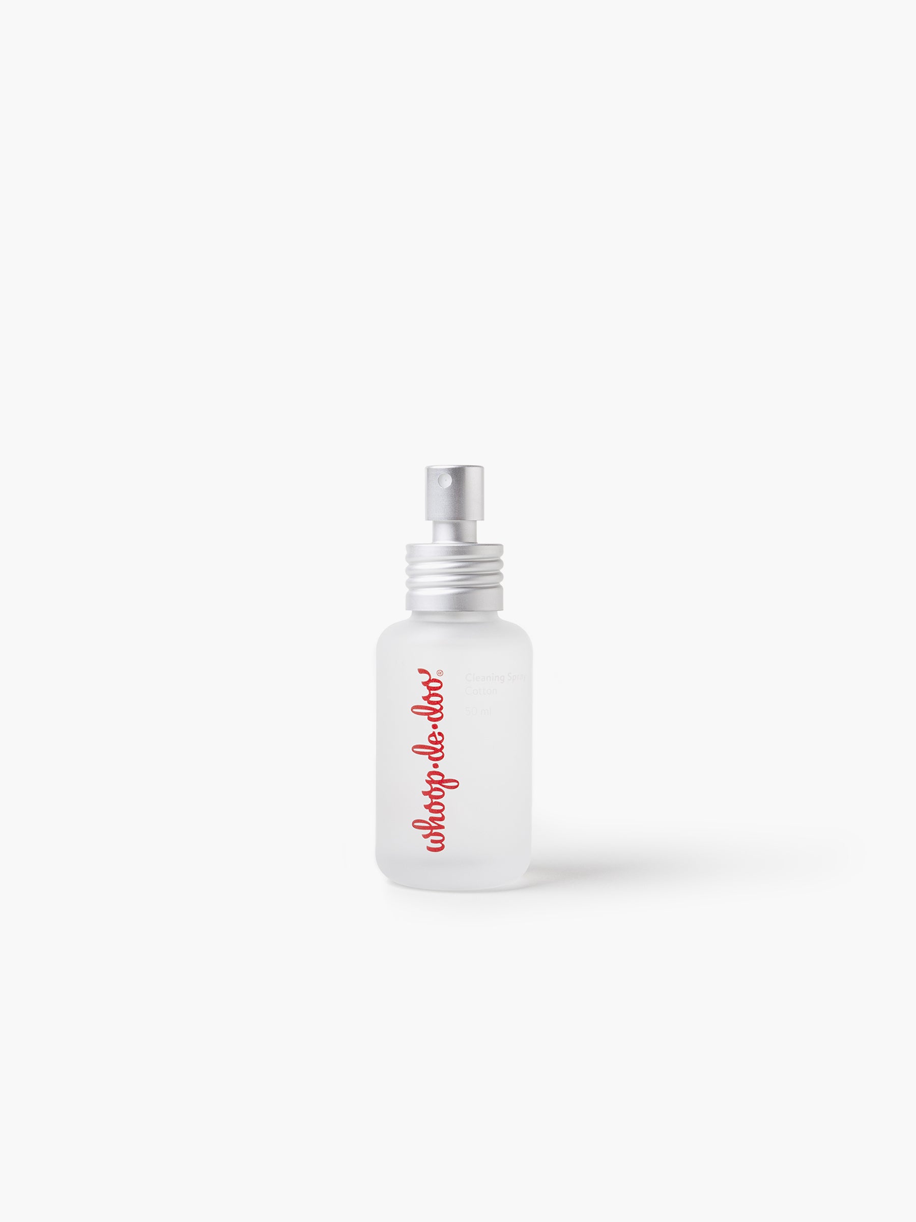 A standalone bottle of Whoop-de-doo Cotton intimate toy cleaning spray made of frosted glass on a clean white background.