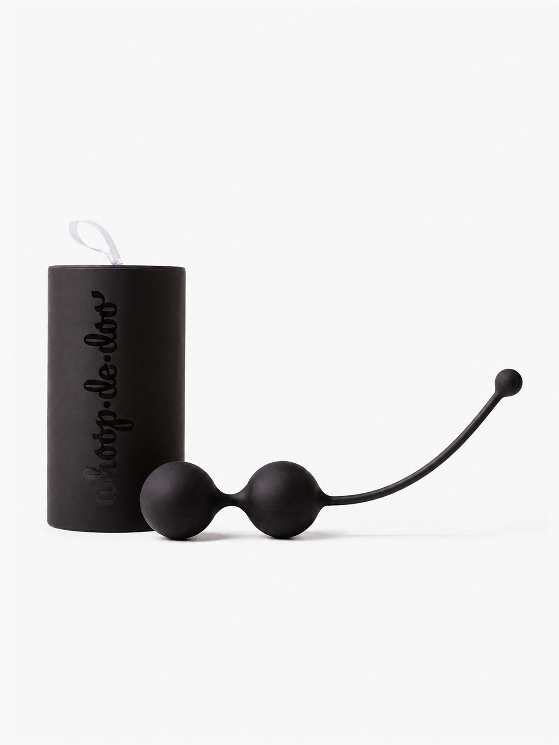 Black Whoop-de-doo Noir Kegel balls made of medical-grade silicone displayed next to an elegant matte black gift tube packaging with logo.