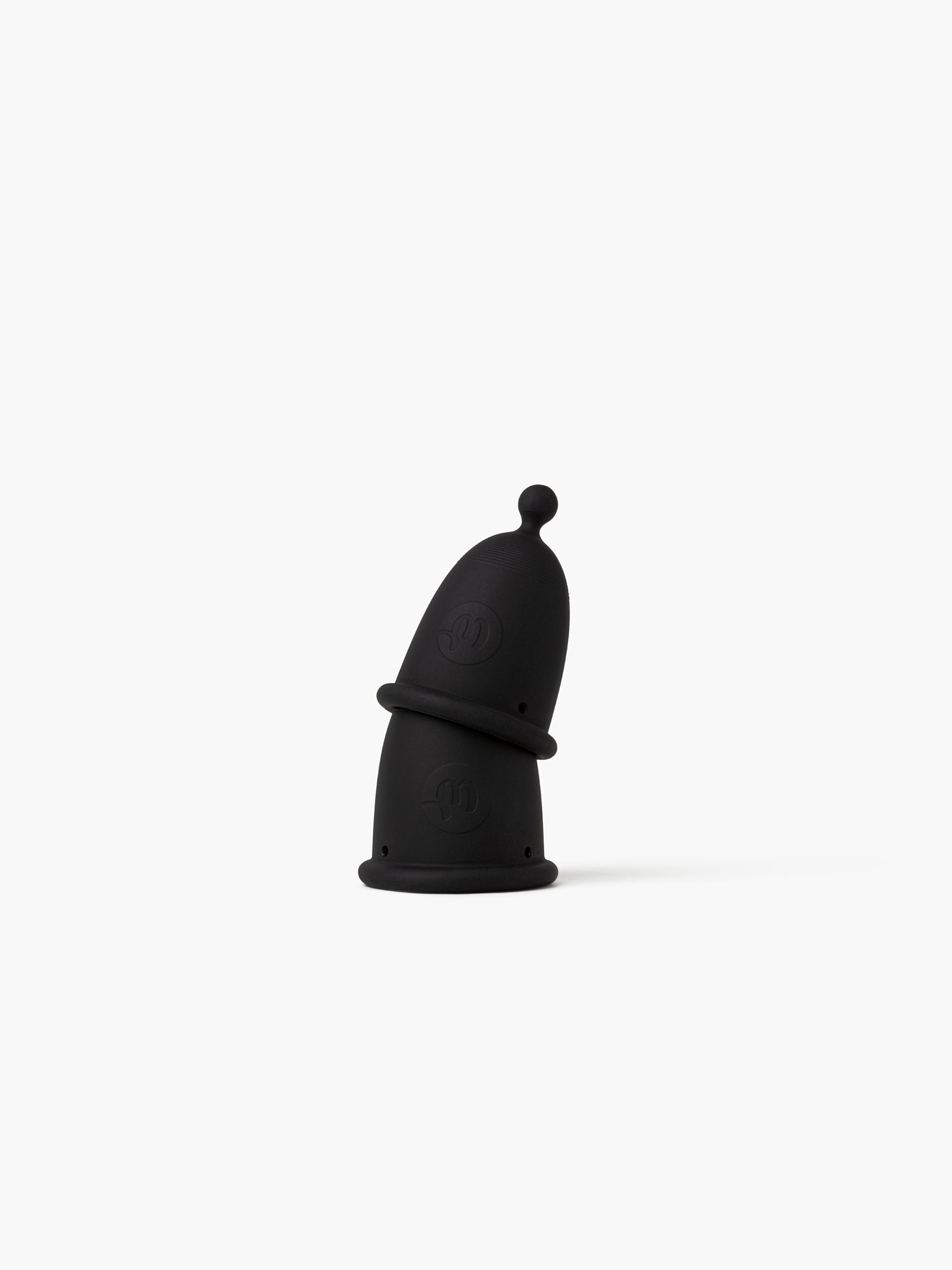 Two black-grey Whoop-de-doo menstrual cups from the Duo pack creatively stacked on top of each other on a white background for Classic and Light size comparison.